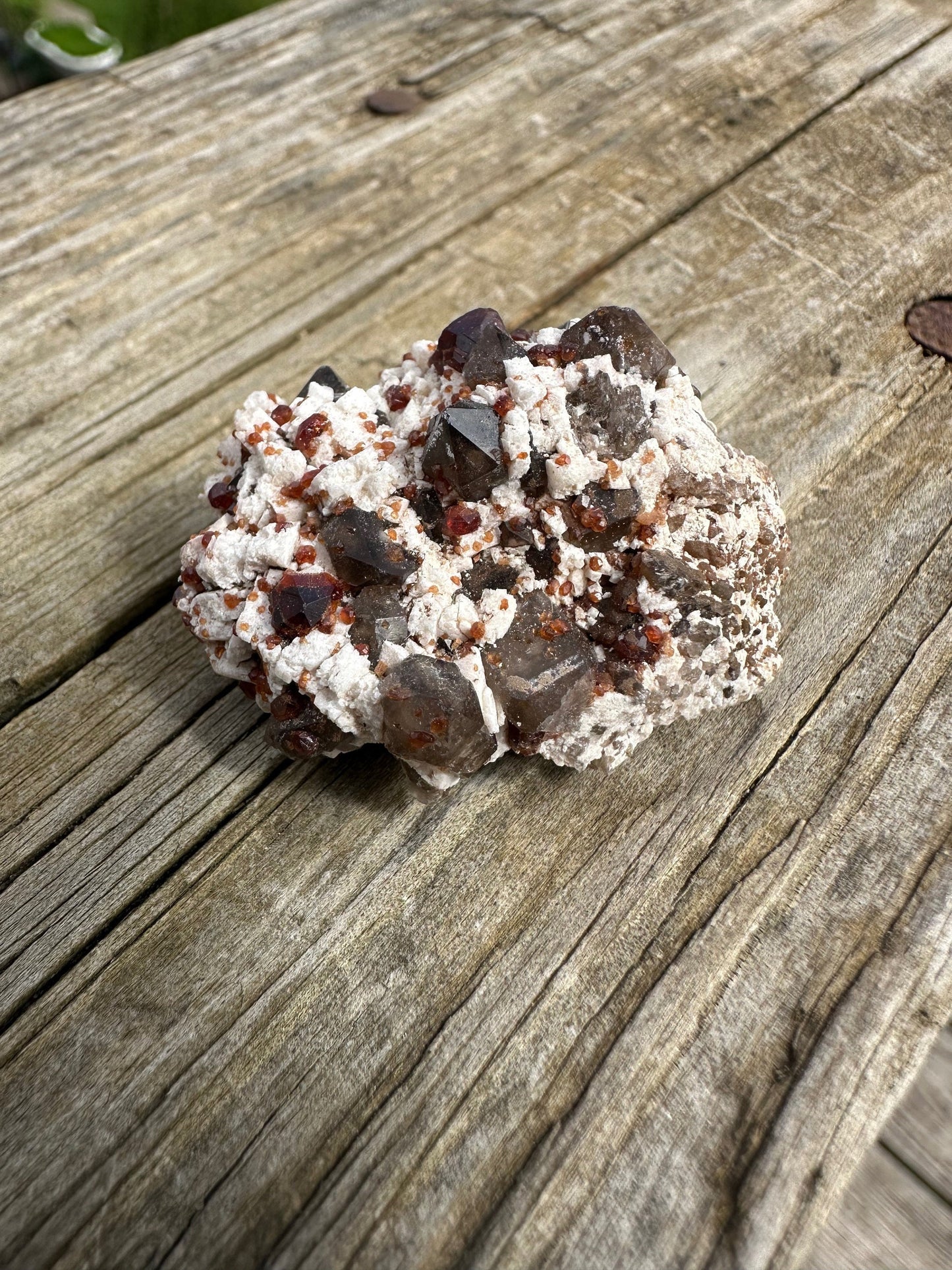 Spessartine Garnets on and in Smoky Quartz on Matrix from China